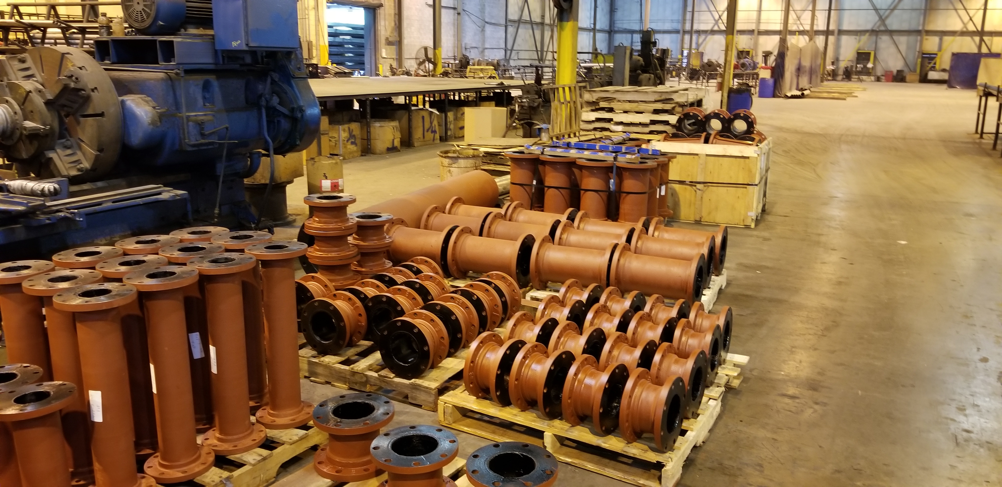 Flanged ductile iron pipe assemblies staged across the Central Pipe & Supply fabrication floor