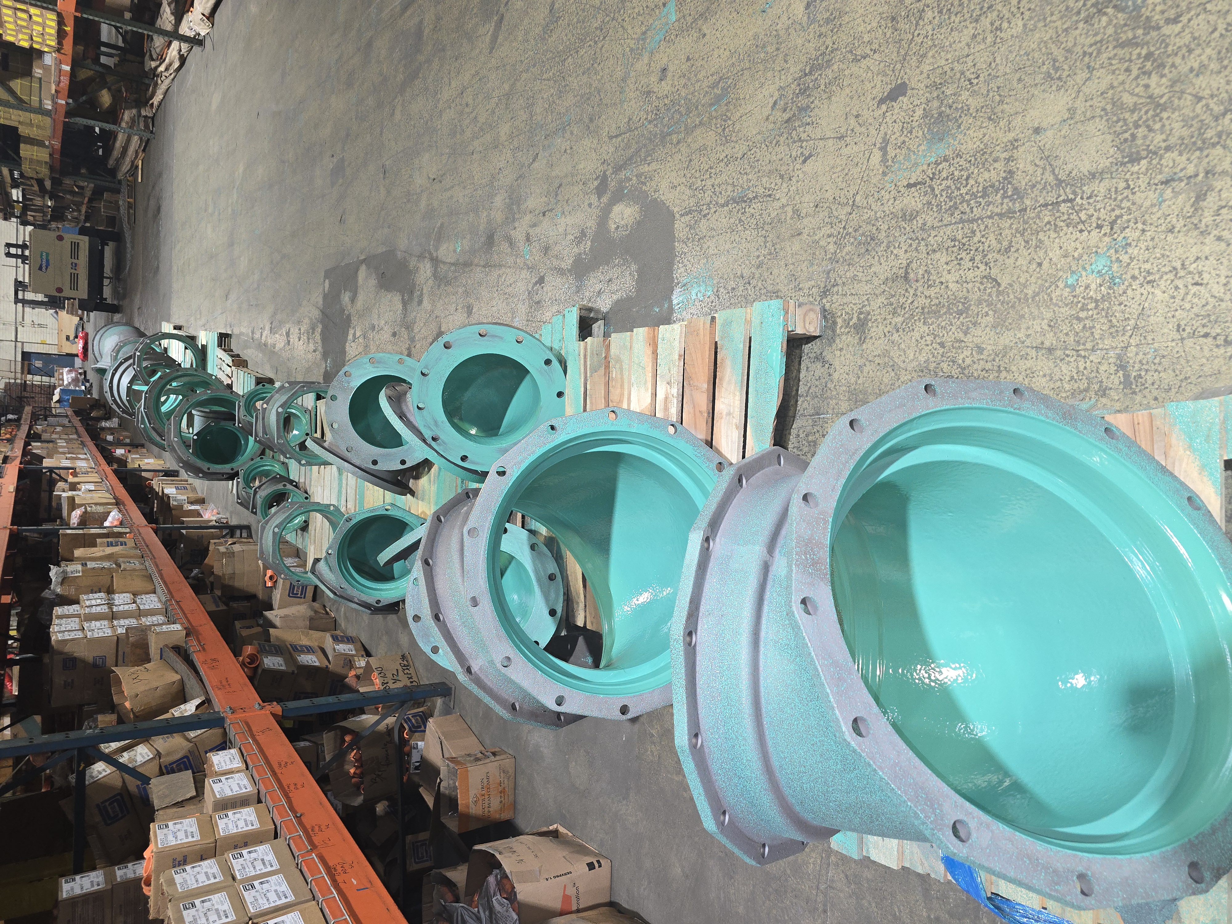 Protective-lined flanged waterworks fittings staged in the Central Pipe & Supply warehouse